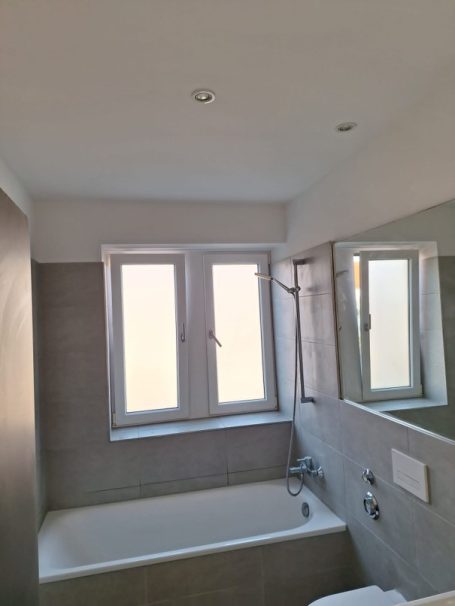 Komplett gefliestes Badezimmer Modernes Badezimmer mit neu verlegten Wand- und Bodenfliesen